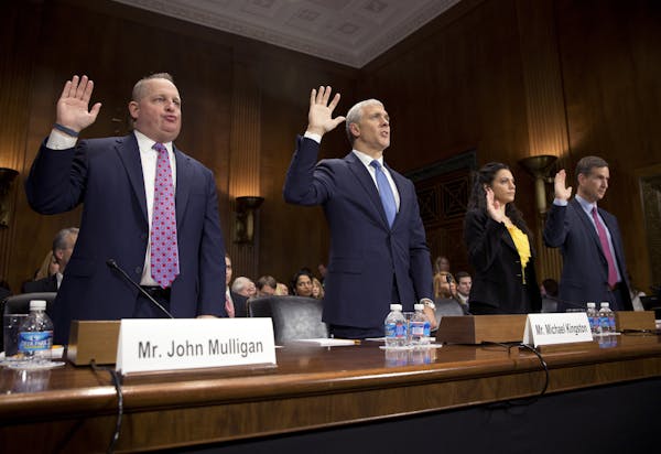 Taking the oath at the start of Tuesday’s Senate Judiciary Committee hearing are, from left, Target chief financial officer John Mulligan, Michael