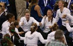 Roseville's team reacted after hearing Northfield's named called as second place knowing that they had won first after the Class 2A gymnastics state m