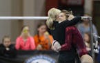 Northfield's Bailey DuPay got a hug from her coach after performing on the uneven bars during the Class 2A gymnastics state meet.