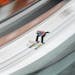 An unidentified athlete makes an attempt in the men's normal hill ski jumping training at the 2014 Winter Olympics, Thursday, Feb. 6, 2014, in Krasnay