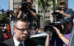 Oscar Pistorius leaves the high court in Pretoria, South Africa, Tuesday, March 25, 2014. Pistorius is charged with murder for the shooting death of h
