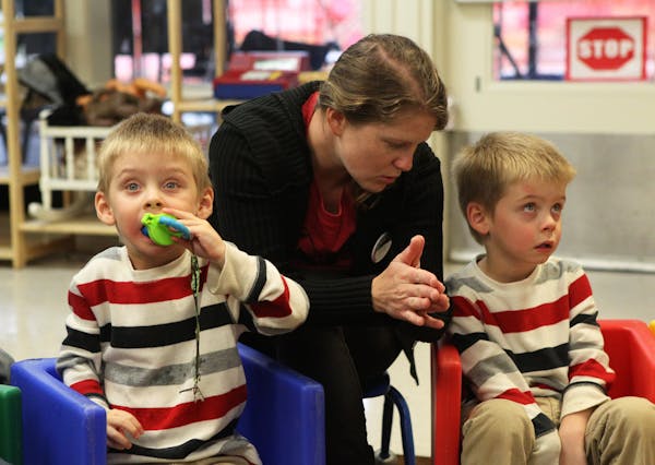 Hannah Ostrowski, an aide at Buckeye Preschool in Redding, Calif., worked with Dylan Ortiz, 3, left, and his twin, Shane Ortiz, both of whom have been