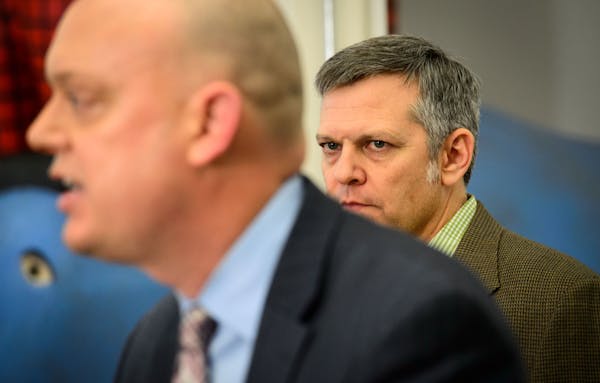MNsure Board Chairman Brian Beutner, right, listened to interim CEO Scott Leitz, who stepped into the fray after CEO April Todd-Malmlov resigned in De