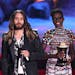 Lupita Nyong'o, right, looks on as Jared Leto accepts the award for best on screen transformation for “Dallas Buyers Club” at the MTV Movie Awards