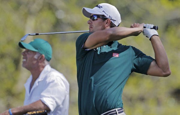 Adam Scott of Australia became the first defending champion to break 70 in the first round since Vijay Singh in 2001.