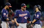 Minnesota Twins starting pitcher Ricky Nolasco (47) gets a visit from shortstop Pedro Florimon, left, and catcher Kurt Suzuki in the fifth inning of a