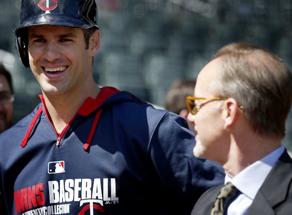 Minnesota Twins Joe Mauer spoke with team owner Jim Pohlad during batting practice before the Twins home opener at Target Field.