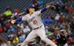 Los Angeles Dodgers starting pitcher Zack Greinke (21) delivers to the Minnesota Twins during the first inning of a baseball game in Minneapolis, Wedn