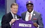 Teddy Bridgewater poses with NFL commissioner Roger Goodell after being selected by the Minnesota Vikings in the first round of the 2014 NFL Draft.