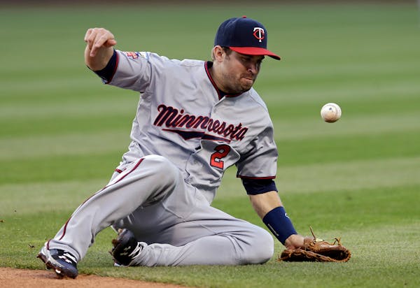 Minnesota Twins second baseman Brian Dozier can't get to a ball hit by Cleveland Indians' David Murphy that goes for a single in the third inning of a