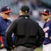 Minnesota Twins manager Ron Gardenhire, left, talks with second base umpire Cory Blaser before challenging a call at second in the third inning of a b