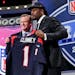 South Carolina defensive end Jadeveon Clowney holds up the jersey for the Houston Texans first pick of the first round of the 2014 NFL Draft with NFL 