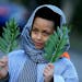 Miles Johnson, 7, waved palms for the "Triumphal entry into Jerusalem" as he participated in the church's re-enactment of the events of Jesus' life an