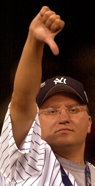 Dave Jepson of Milwaukee displayed a thumbs-down after the 2002 All-Star Game at Miller Park was called at the end of the 11th inning tied 7-7.