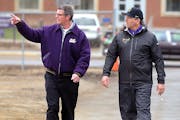 Minnesota State, Mankato athletic director Kevin Buisman, left, walks with football coach Todd Hoffner before Hoffner's first practice after being rei