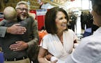 With her husband, Marcus, by her side, U.S. Rep. Michele Bachmann met supporters during a tribute to her at Monticello High School last month. “I’