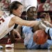 North Carolina's Waltiea Rolle and Boston College's Katie Zenevitch (45) compete for a loose ball during the first half of an NCAA college basketball 