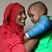 Fadumo Abudllahi holds her son, Musa, 16, months, a month after Musa fell 11 stories from the family's Cedar-Riverside apartment.