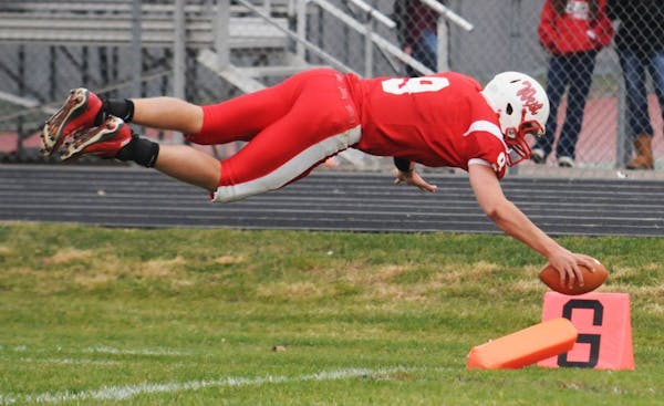 Mankato West's Philip Nelson dives into the endzone for a touchdown during his senior year in 2011. He's facing assault charges and an uncertain fate 