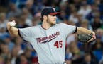 Minnesota Twins starting pitcher Phil Hughes works against the Toronto Blue Jays during the first inning of a baseball game in Toronto on Wednesday, J