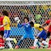 Mexico's goalkeeper Guillermo Ochoa (13) bats the ball away after a header by Brazil's Fred, left, during the group A World Cup soccer match between B