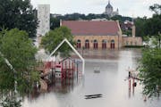 The Harriet Island pavilion and playground are surrounded by the flood waters of the Mississippi River, Tuesday, in St. Paul.