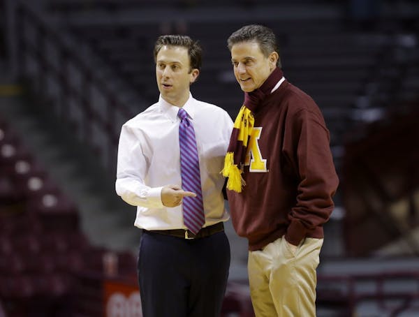 Minnesota head coach Richard Pitino, left, poses with his father and Louisville head coach Rick Pitino, right.