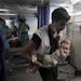 Friday, July 18, 2014: A Palestinian medic carries a wounded girl at the emergency room of the Shifa hospital in Gaza City.