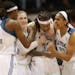 Seimone Augustus of the Minnesota Lynx is surrounded by teammates, from left, Rebekkah Brunson, Lindsay Whalen and Maya Moore during the WNBA Finals l