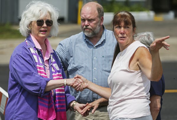 Scott Patrick's brother, Mike Brue, center, arrived at the scene from his home in Alvarado, Minn., with friends Mary Sweeney, left, and Nancy Appenzel