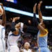 Minnesota Lynx forward Devereaux Peters (14) goes up for a rebound with forward Maya Moore, center, and Chicago Sky forward Tamera Young, right, in th