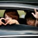 Scott Patrick's wife, Michelle, right, and one of their daughters show signs of love to the crowd as they entered Acacia Park Cemetery on Wednesday, A