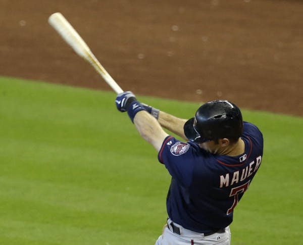 Minnesota Twins' Joe Mauer swings for a solo home run against the Houston Astros in the sixth inning of a baseball game Wednesday, Aug. 13, 2014, in H