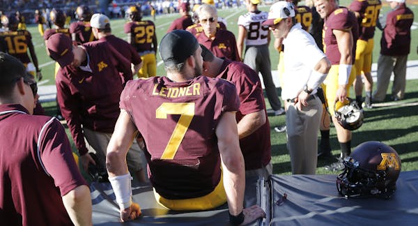Minnesota staff worked on Minnesota sophomore quarterback Mitch Leidner's knee injury in the third quarter as the Minnesota Gophers took on Middle Ten