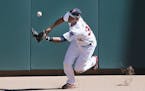 Minnesota Twins center fielder Aaron Hicks (32) reached for a triple hit by Los Angeles Angels first baseman C.J. Cron (20) in the firth inning. The M