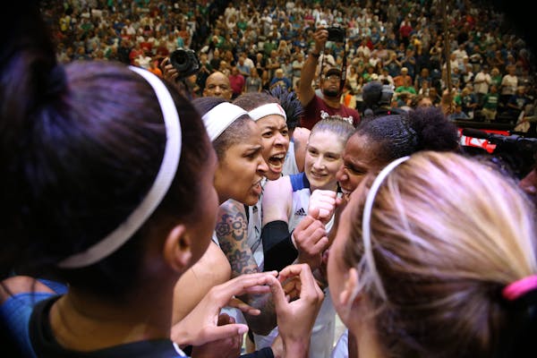 From center left, Maya Moore, Seimone Augustus and Lindsay Whalen celebrated Sunday's Lynx victory with teammates.