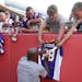 Minnesota Vikings running back Adrian Peterson signed autographs before an NFL preseason football game against the Kansas City Chiefs in Kansas City, 