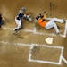 Miami Marlins' Giancarlo Stanton falls down after being hit in the face with a pitch during the fifth inning of a baseball game against the Milwaukee 