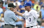 Kansas City Royals manager Ned Yost (3) tries to argue a ruling by umpire Larry Vanover that resulted in Salvador Perez being called out for not taggi
