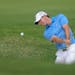Rory McIlroy, of Northern Ireland, hits out of a bunker on the seventh hole during the third round of play in the Tour Championship golf tournament Sa