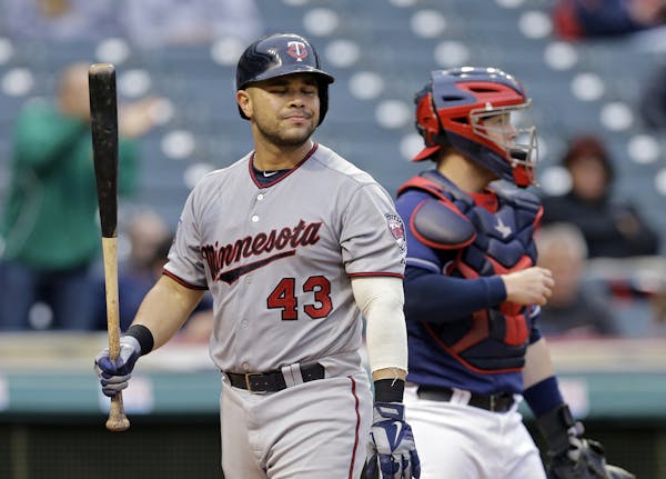 Minnesota Twins' Josmil Pinto walks back to the dugout after striking out against Cleveland Indians starting pitcher T.J. House in the seventh inning 