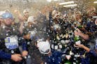 Kansas City Royals players and coaches celebrate with champagnes after the Royals defeated the Chicago White Sox 3-1 in a baseball game in Chicago on 