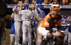 Kansas City Royals' Terrance Gore (0) is congratulated by teammates after scoring on a double by Alcides Escobar during the ninth inning of Game 2 of 