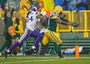 Green Bay Packers outside linebacker Julius Peppers (56) ran for a touchdown after a fumble despite pressure from Minnesota Vikings wide receiver Cord