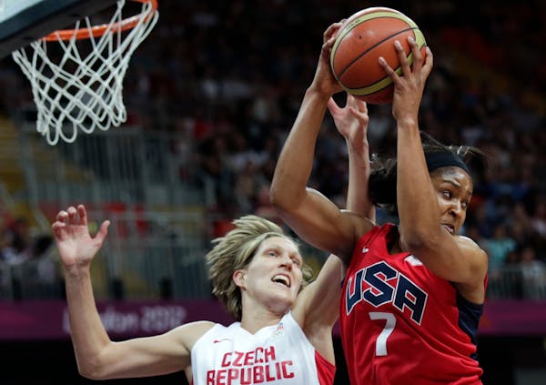 USA's Maya Moore, right, hauls down a rebound against Czech Republic's Jana Vesela during a women's basketball game at the 2012 Summer Olympics, Frida