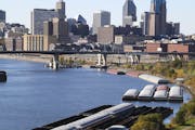 Though these St. Paul scenes look tranquil, this fall has been a particularly difficult season for barges up and down the Mississippi.