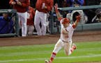 St. Louis Cardinals' Kolten Wong is congratulated after hitting a walk off home run during the ninth inning in Game 2 of the National League baseball 