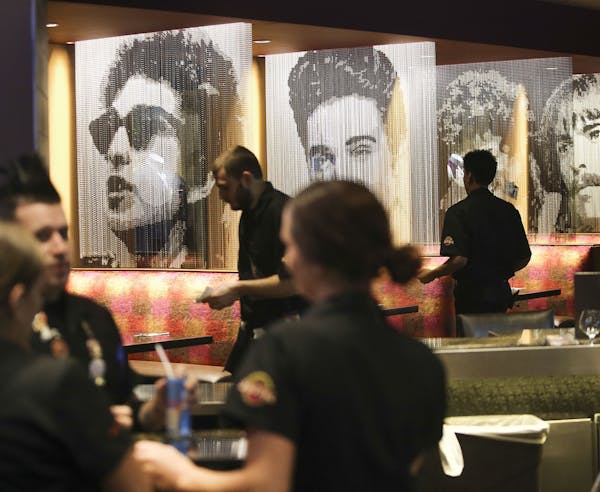 Images of rock icons separate booths at the Hard Rock.