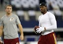 Washington Redskins quarterback Colt McCoy, left, and quarterback Robert Griffin III (10) warm up before an NFL football game against the Dallas Cowbo