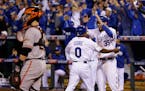 Kansas City Royals Terrance Gore (0) celebrates with his teammate Eric Hosmer, right, after scoring on an RBI doubly by Salvador Perez during the sixt